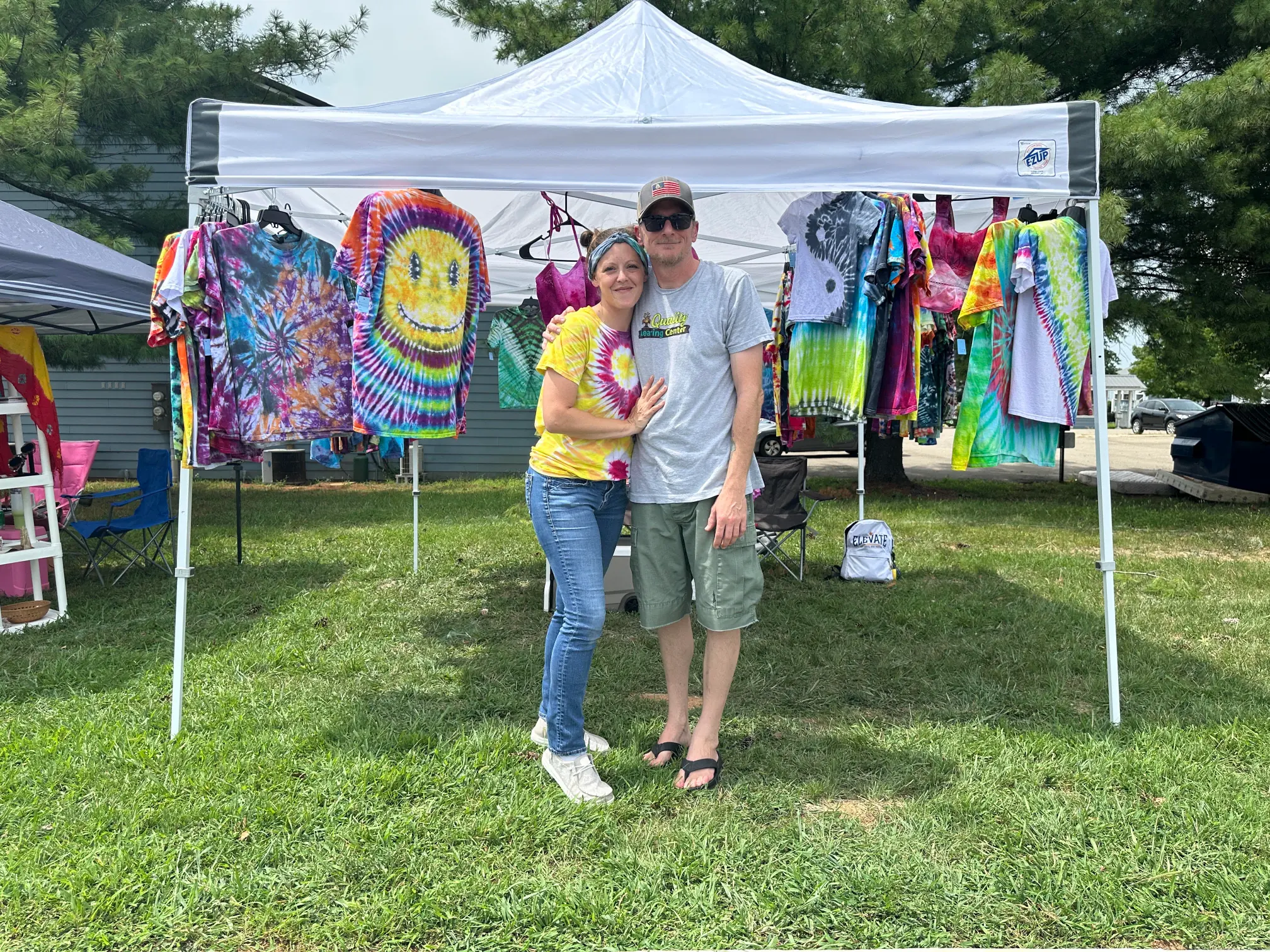 Dye Diff'rnt booth displaying hand-dyed clothing at an outdoor event
